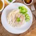 hainanese boiled chicken rice on the wooden table hainanese boiled chicken rice on the wooden table